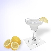 Margarita served in a margarita glass with lemon decoration and a sugar or salt rim.